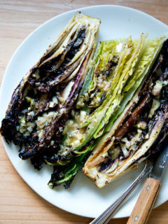 A plate of "grilled" Romaine salad with anchovy dressing.
