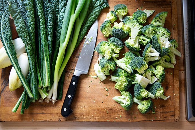 A cutting board with chopped broccoli.