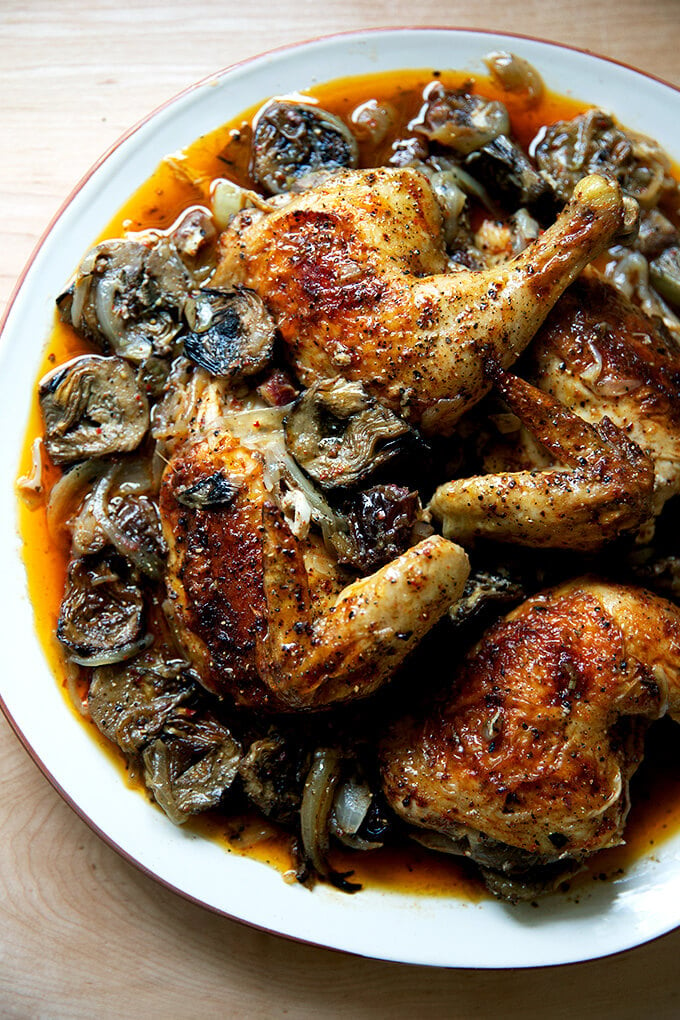 A platter of roast chicken with dates and artichoke hearts.
