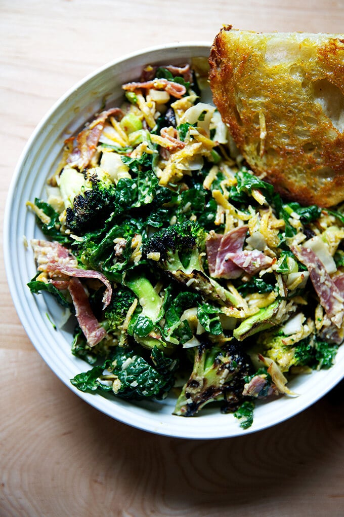 A bowl of chopped salad with cashew dressing aside toasty bread