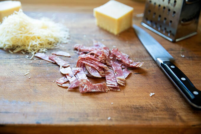 Chopped salami on a cutting board.