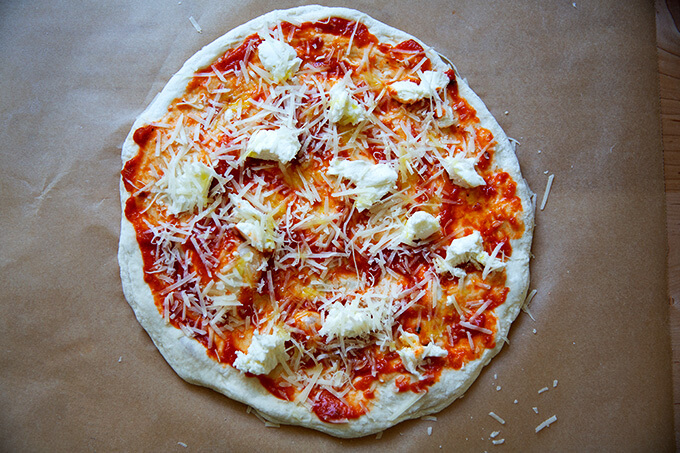 Stretched and topped sourdough pizza round.