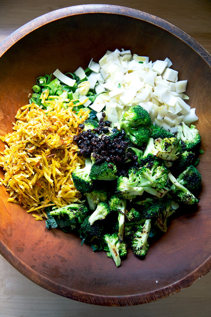 A large salad bowl filled with the vegetables for a chopped salad.