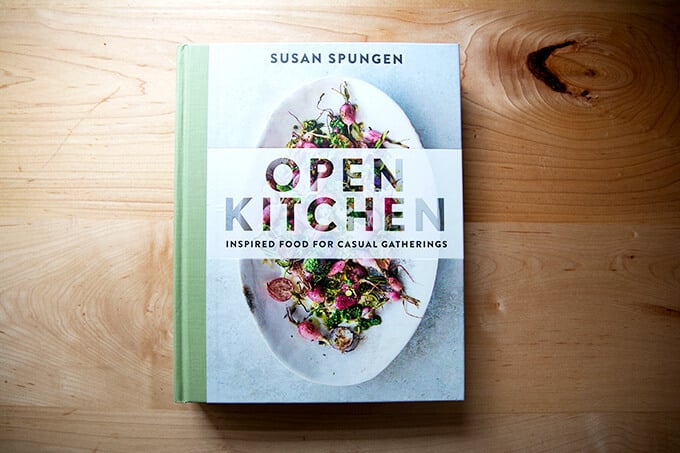 A cookbook, Open Kitchen, on the counter.