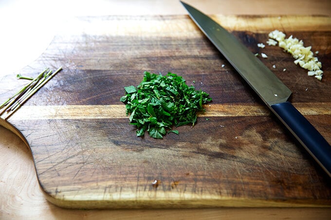 Mint and garlic chopped on a board.