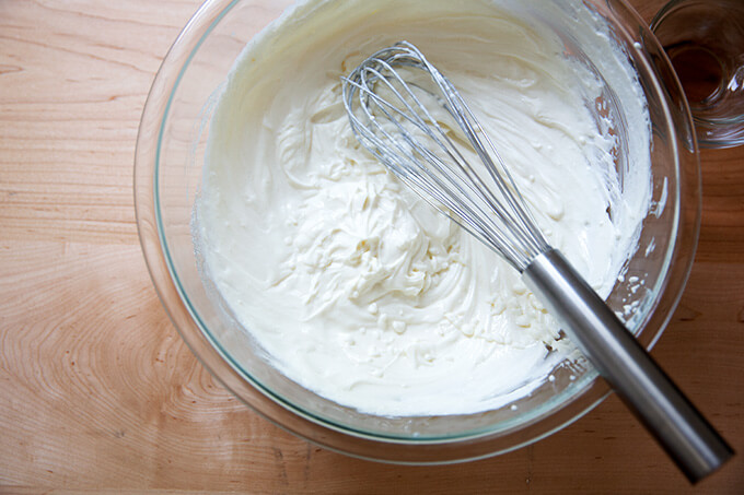 A bowl of whisked yogurt, vanilla, and sugar.