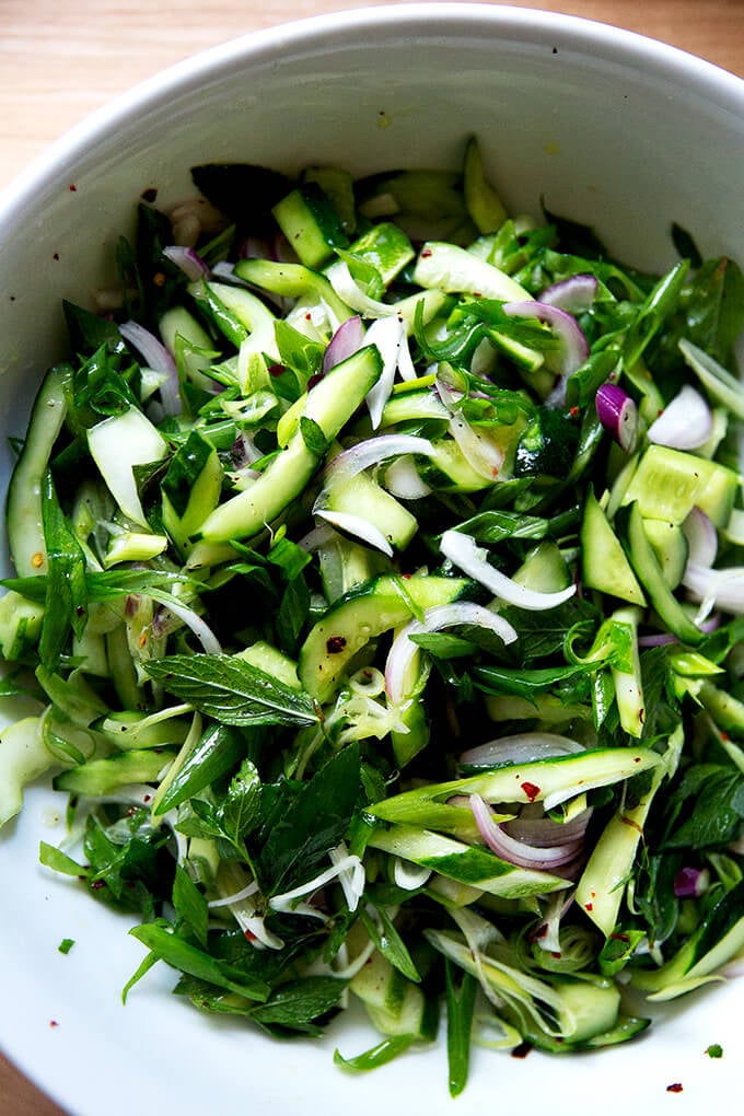 Tossed cucumber salad in bowl.