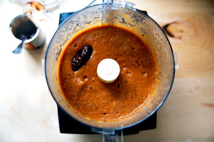 Puréed enchilada sauce in a food processor with a chipotle in adobo sauce added.