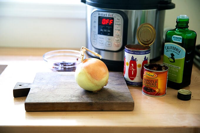Ingredients for making Instant Pot chicken tinga on a board.