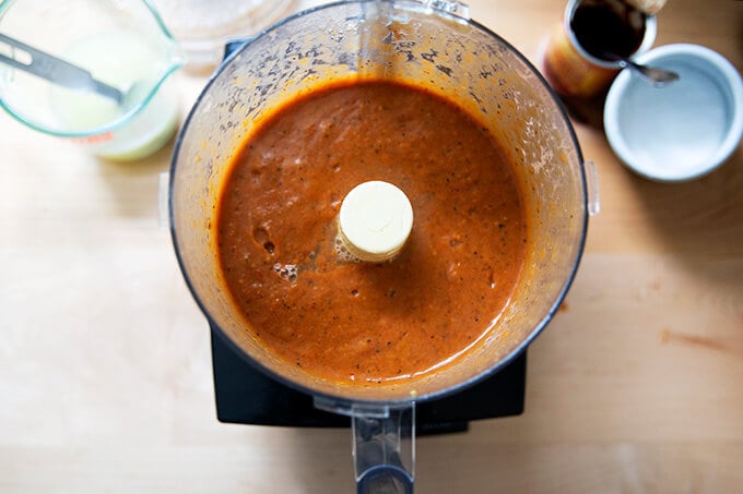 Puréed enchilada sauce in a food processor with fresh lime juice and salt added.