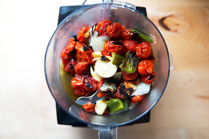 Broiled vegetables in a food processor, ready to be puréed.