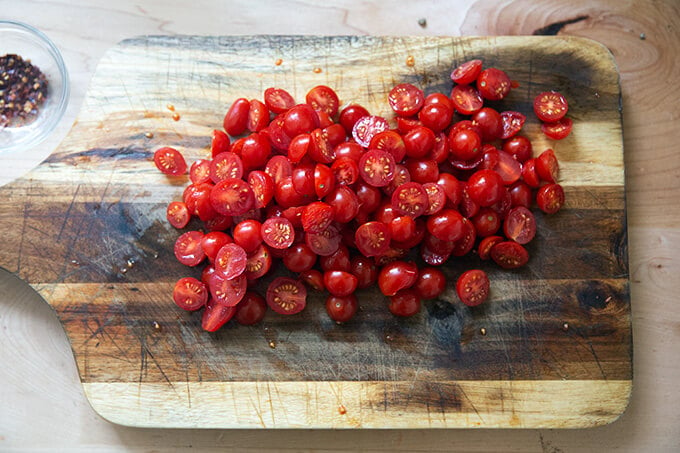 A board of halved cherry tomatoes.