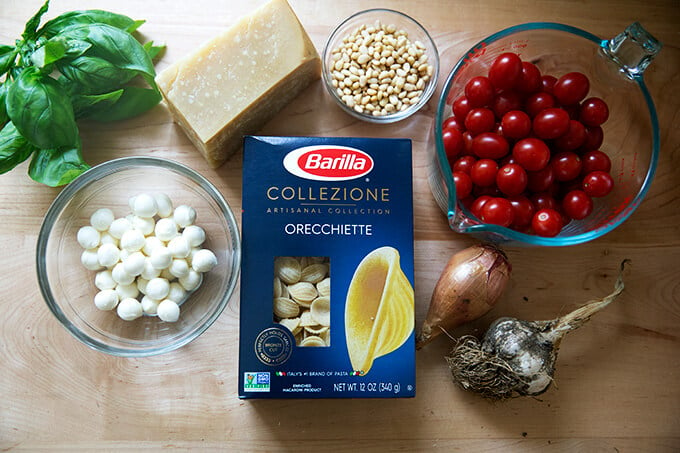 The ingredients to make pasta with cherry tomatoes, pine nuts, and mozzarella.