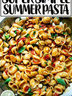 A skillet of pasta tossed with cherry tomato sauce, pine nuts, basil and mozzarella.