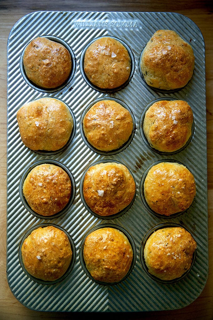 An overhead shot of thyme dinner rolls in a muffin tin.