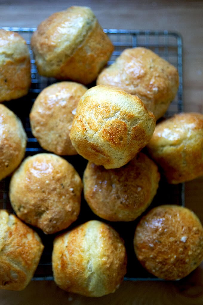 Thyme dinner rolls on a cooling rack.