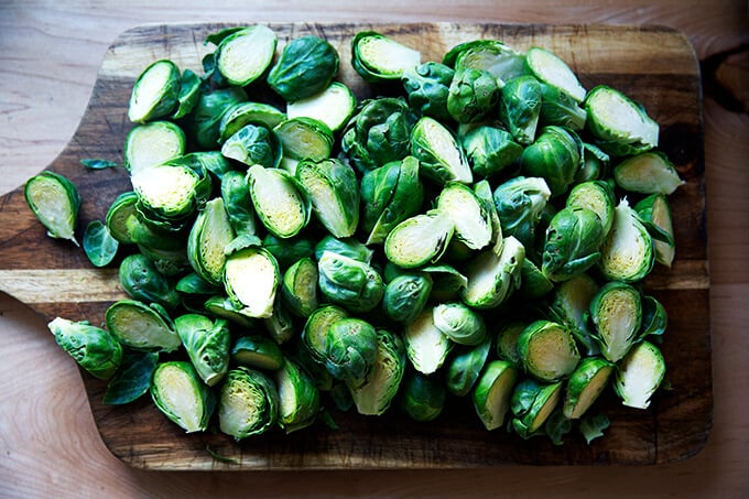 Halved Brussels sprouts on a board.