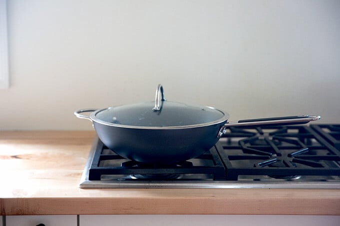 A wok on a stovetop.