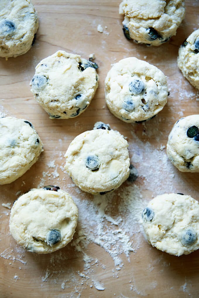 Cut blueberry scones on a work surface.