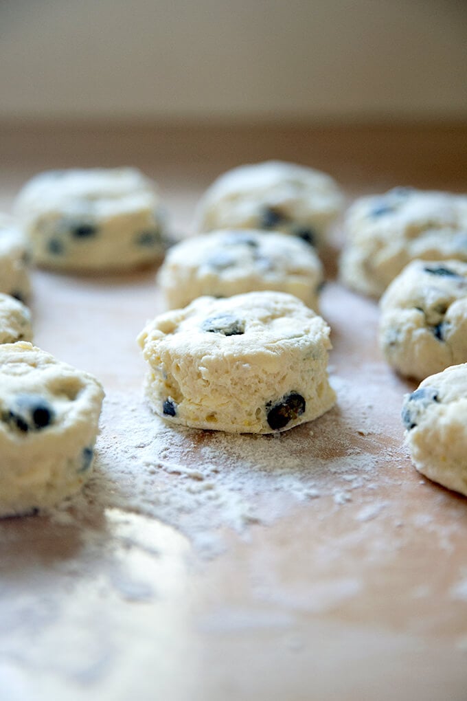 Cut blueberry scones on a work surface.