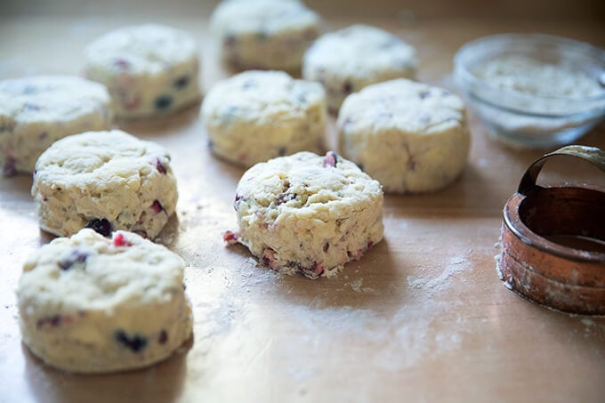 Cut cranberry scones on a work surface.