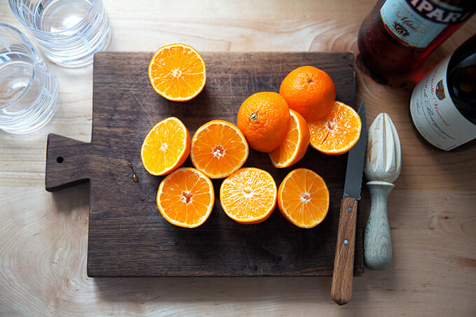 Halved clementines on a board.