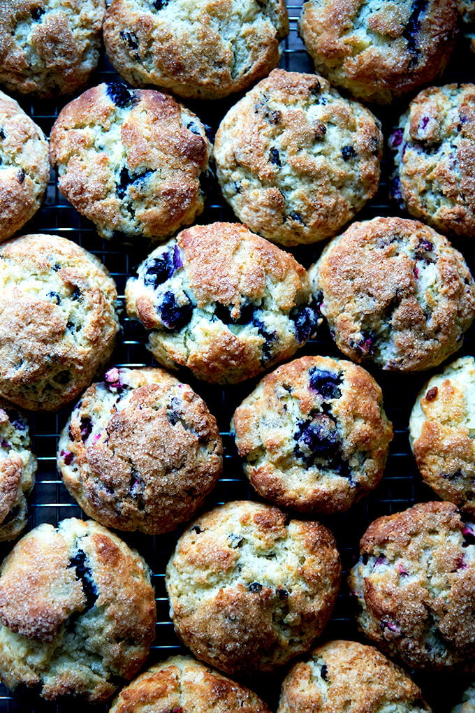 A cooling back covered with a variety of just-baked scones.