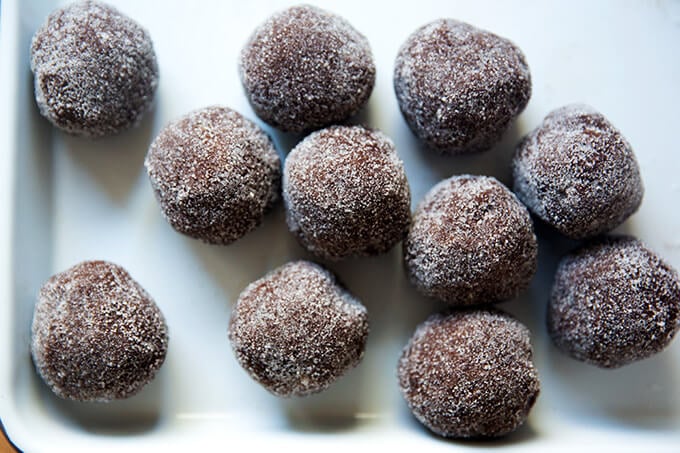 Portioned chocolate sugar cookie balls, rolled in sugar.