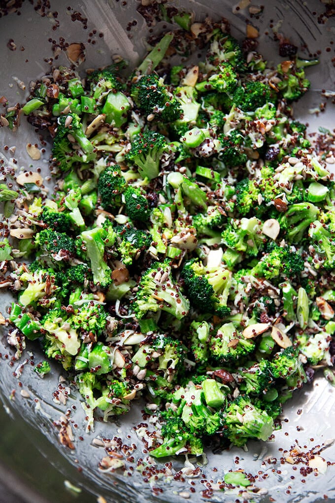 A large bowl tossed with broccoli-quinoa salad.