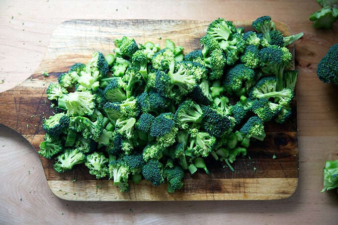 Chopped broccoli on a cutting board.