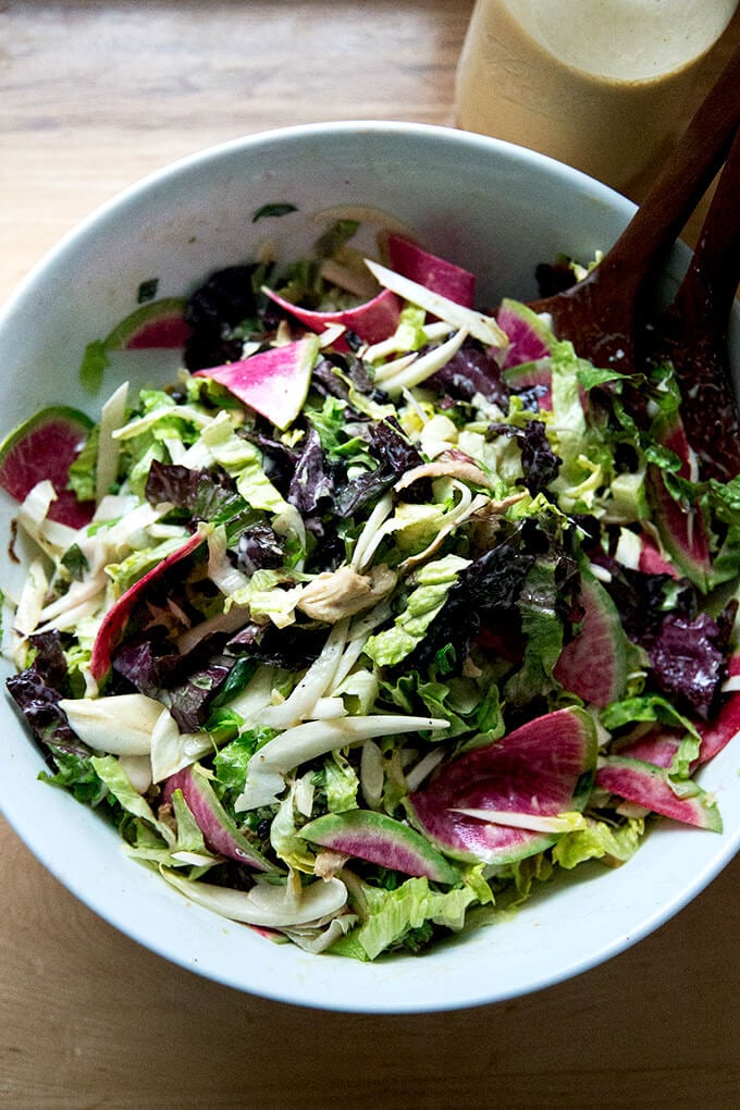 A large chopped salad tossed with tahini dressing.