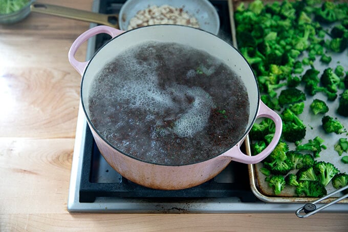 A large pot of water boiling quinoa.