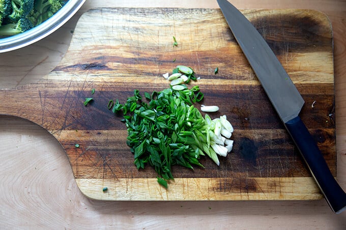 Chopped scallions on a board.