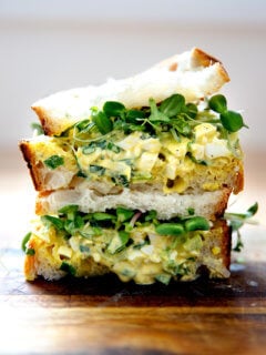 The best egg salad sandwich on a board.