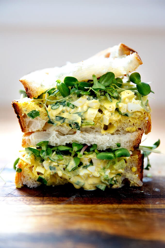 The best egg salad sandwich on a board.