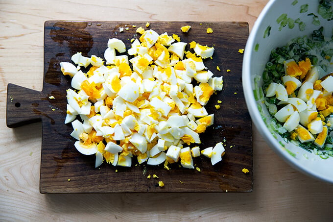 Chopped hard-boiled eggs on a board.