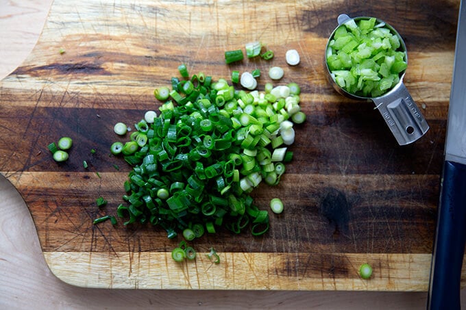 Sliced scallions on a board.