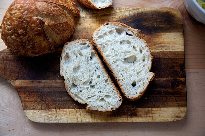 Two slices of sourdough bread on a cutting board.