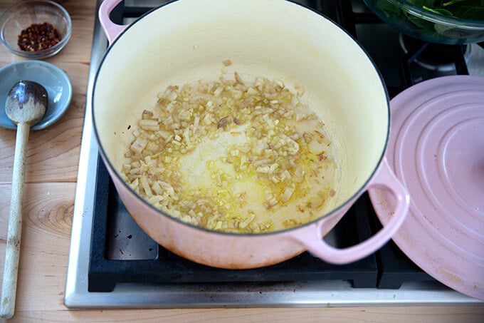 Sautéed shallots in a Dutch oven.