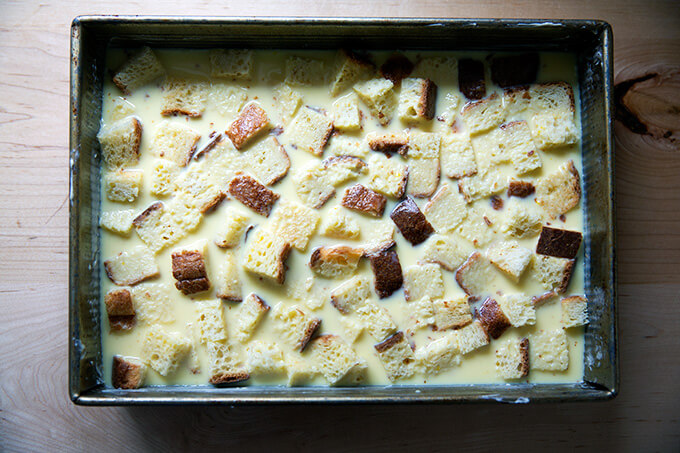 A 9x13-inch pan filled with toasted brioche cubes soaked in a custard.
