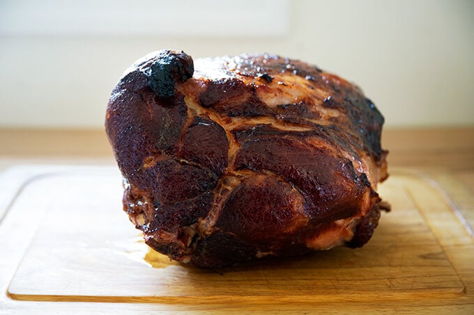 A roasted, brown sugar glazed ham resting on a platter.