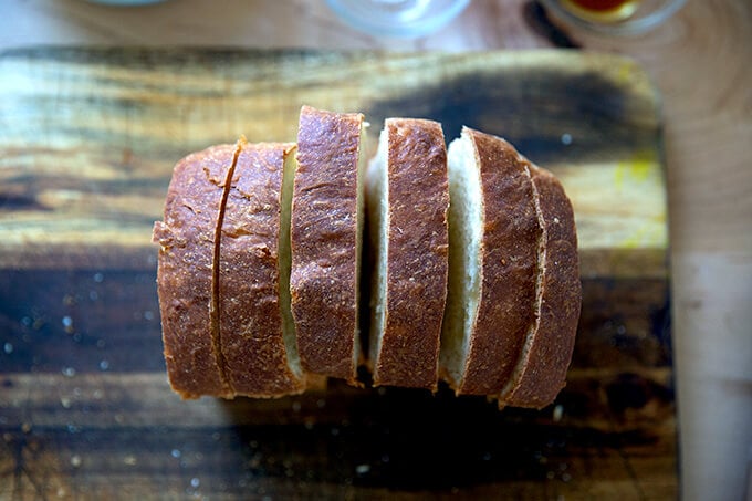 Six slices of brioche on a cutting board.