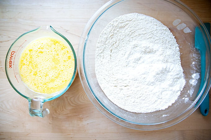 Wet and dry ingredients in bowls to make brioche bread.