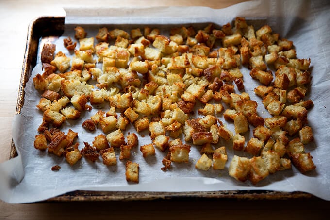A sheet pan of olive oil croutons.