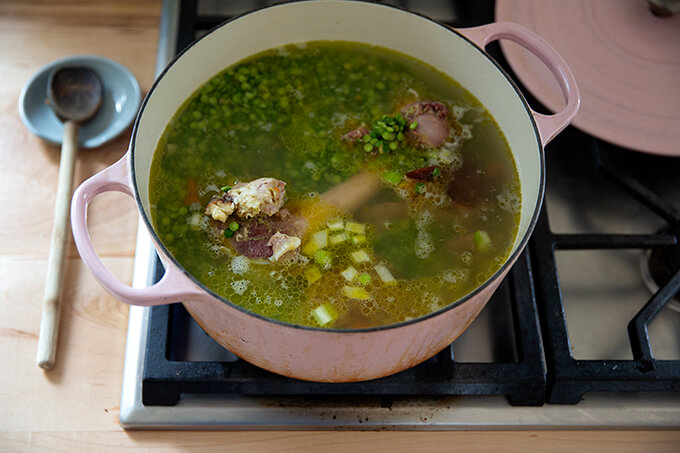 A large pot filled with the ingredients to make split pea and ham soup.