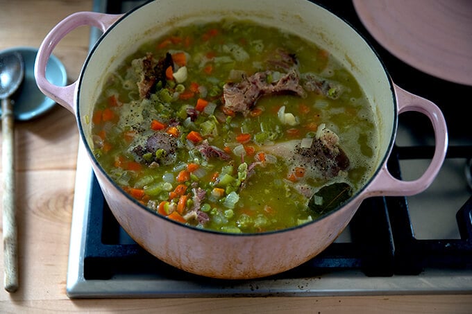 A large pot filled with finished split pea and ham soup.