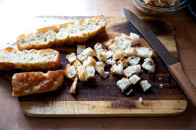 Cube focaccia bread on a board.