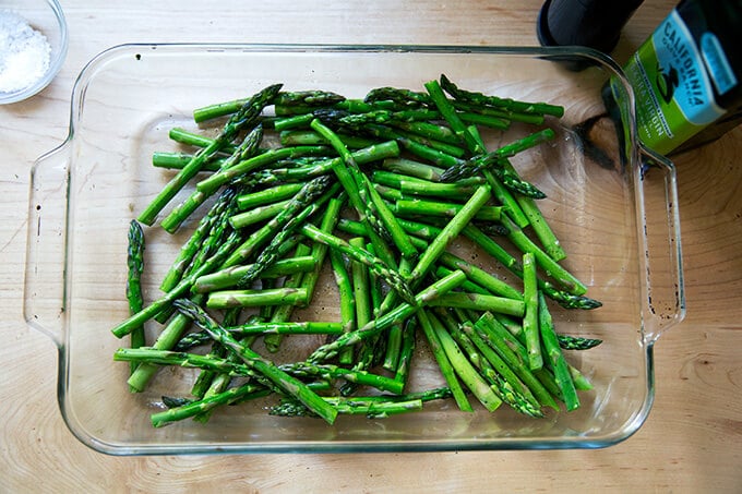 Asparagus, seasoned with salt and pepper, unbaked in a baking dish.