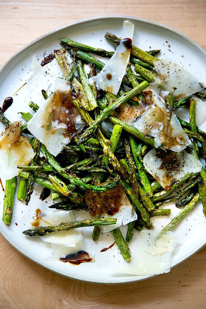 Roasted asparagus with balsamic and parmesan on a plate.