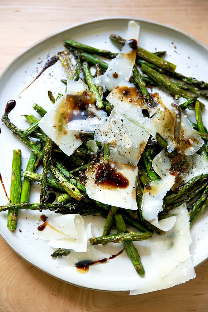 Roasted asparagus with balsamic and parmesan on a plate.